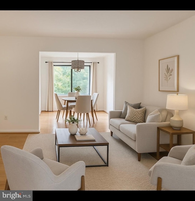 10627 Muirfield Dr, Potomac, MD 20854 - living room with light wood-style flooring, baseboards, and a chandelier