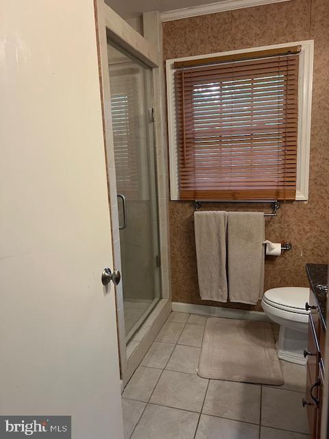232 N Shore Ct, Seaford, DE 19973 - bathroom with tile patterned floors, a shower stall, vanity, crown molding, and toilet