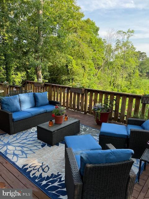 232 N Shore Ct, Seaford, DE 19973 - wooden deck featuring an outdoor hangout area