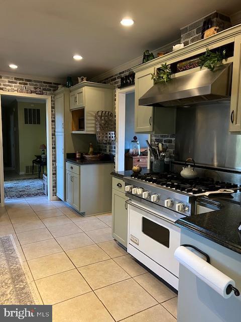 232 N Shore Ct, Seaford, DE 19973 - kitchen featuring high end stainless steel range oven, dark countertops, wall chimney range hood, light tile patterned floors, and recessed lighting