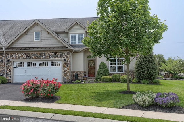 126 Windermere Dr, Palmyra, PA 17078 - view of front of property featuring stone siding, a front lawn, driveway, an attached garage, and a shingled roof
