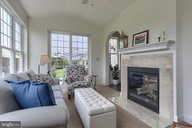 126 Windermere Dr, Palmyra, PA 17078 - living room with lofted ceiling, ceiling fan, a high end fireplace, baseboards, and arched walkways