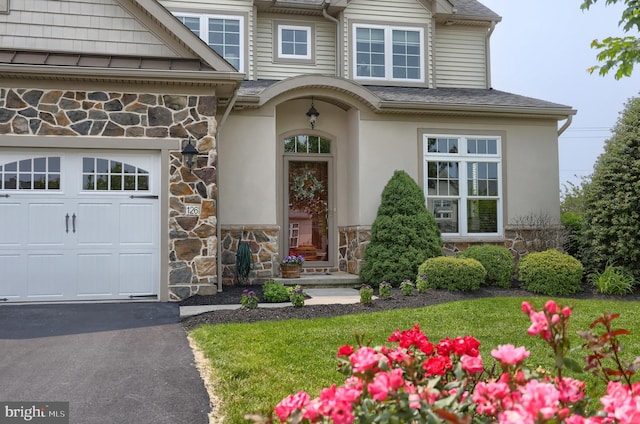 126 Windermere Dr, Palmyra, PA 17078 - property entrance featuring stone siding, an attached garage, stucco siding, and a shingled roof
