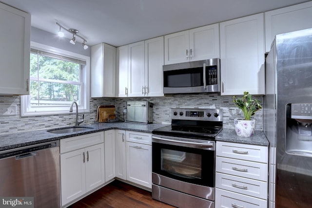 3574 Brickwall Ln, Pasadena, MD 21122 - kitchen with stainless steel appliances, a sink, dark stone counters, and white cabinets