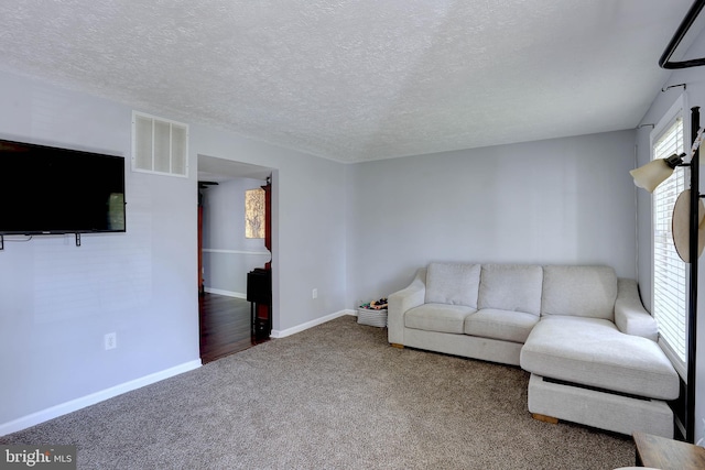 3574 Brickwall Ln, Pasadena, MD 21122 - carpeted living area featuring a textured ceiling and baseboards