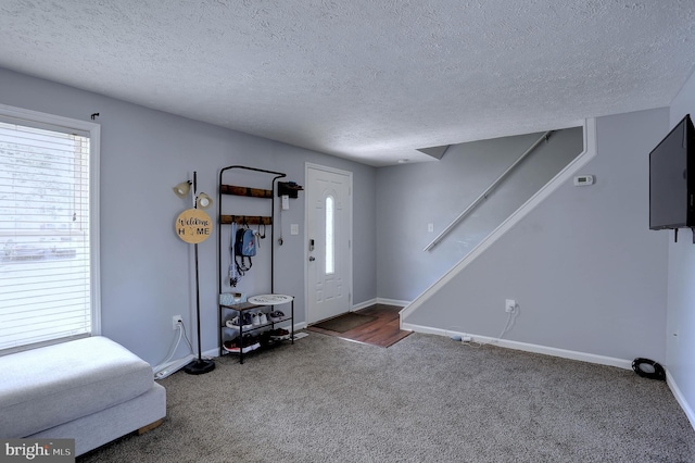 3574 Brickwall Ln, Pasadena, MD 21122 - entryway with a textured ceiling, carpet, stairway, and baseboards
