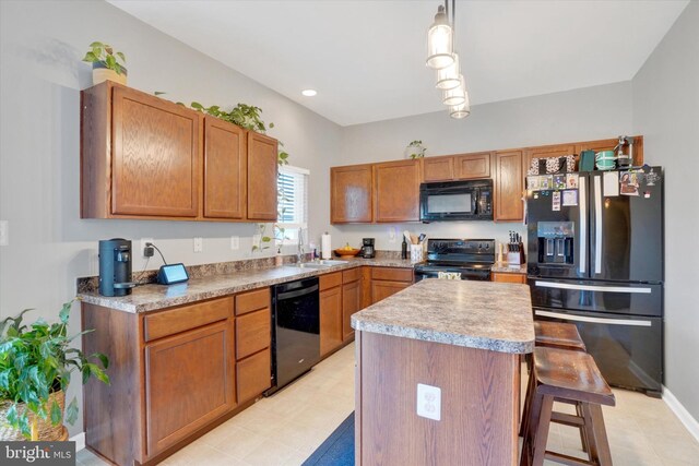 4140 Strawbridge Ct, Dover, PA 17315 - kitchen featuring black appliances, a sink, a breakfast bar, a kitchen island, and light countertops