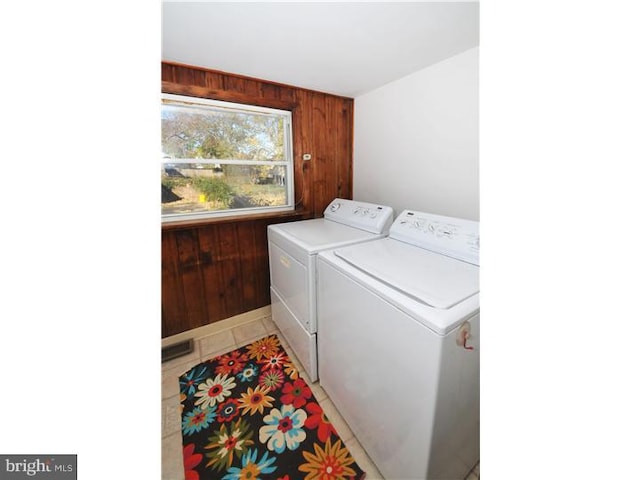 7728 Union Ave, Elkins Park, PA 19027 - laundry room featuring washer and clothes dryer, wooden walls, and light tile patterned floors