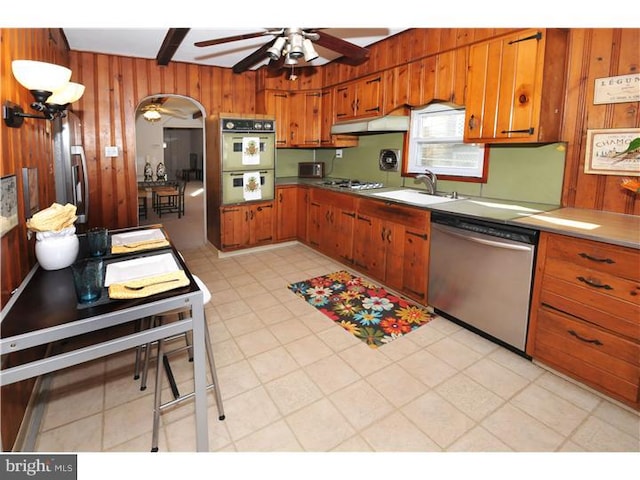 7728 Union Ave, Elkins Park, PA 19027 - kitchen featuring stainless steel dishwasher, a sink, wood walls, a ceiling fan, and brown cabinetry
