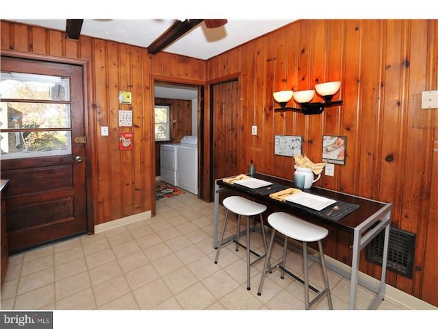 7728 Union Ave, Elkins Park, PA 19027 - dining space featuring washing machine and dryer, ceiling fan, wood walls, and light flooring