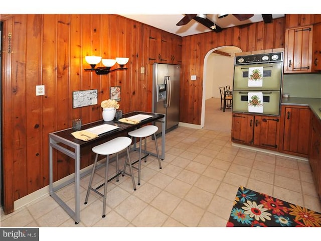 7728 Union Ave, Elkins Park, PA 19027 - dining room with arched walkways, ceiling fan, and wooden walls