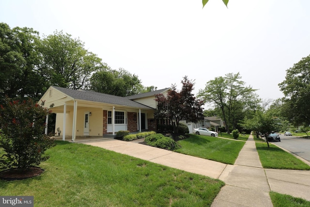 7009 Wood Thrush Dr, Lanham, MD 20706 - tri-level home with a front lawn, a carport, a porch, and brick siding