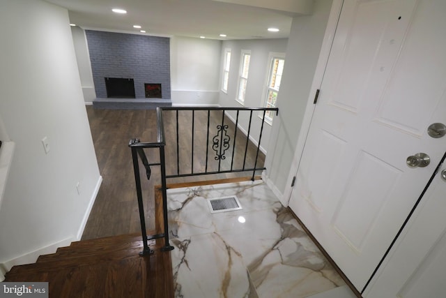 7009 Wood Thrush Dr, Lanham, MD 20706 - staircase with a brick fireplace, recessed lighting, baseboards, and wood finished floors