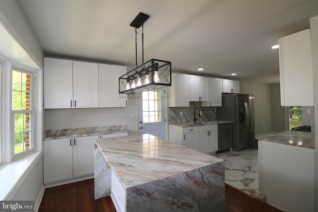 7009 Wood Thrush Dr, Lanham, MD 20706 - kitchen featuring appliances with stainless steel finishes, healthy amount of natural light, light stone counters, white cabinets, and recessed lighting