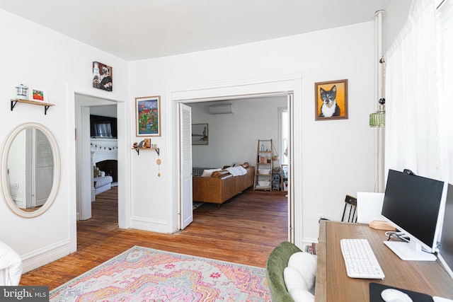510 E Main St, Birdsboro, PA 19508 - office featuring a wall unit AC, wood finished floors, baseboards, and a fireplace