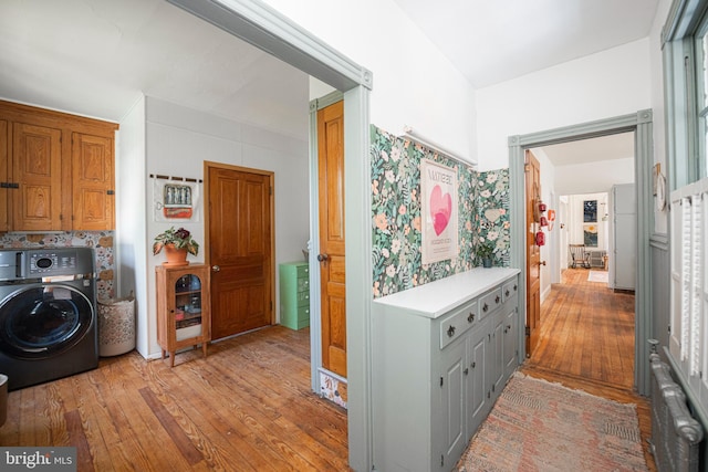 510 E Main St, Birdsboro, PA 19508 - laundry area featuring washer / dryer, cabinet space, radiator heating unit, and light wood-style floors