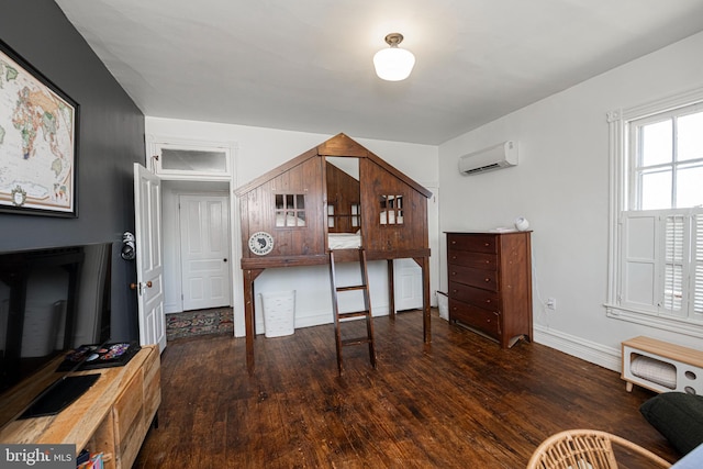 510 E Main St, Birdsboro, PA 19508 - bedroom featuring a wall unit AC, wood finished floors, and baseboards