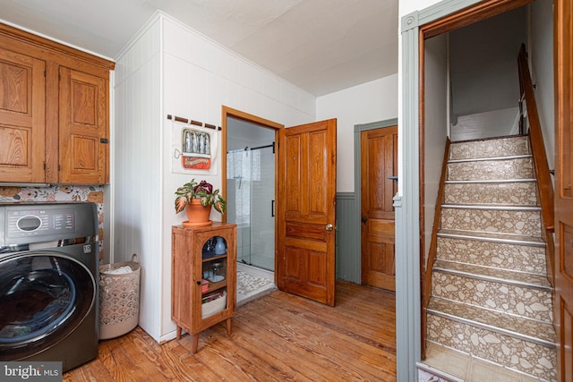 510 E Main St, Birdsboro, PA 19508 - washroom featuring washer / dryer, cabinet space, light wood-type flooring, and ornamental molding