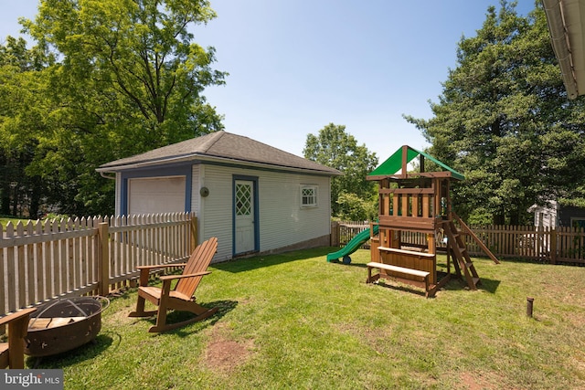 510 E Main St, Birdsboro, PA 19508 - view of yard featuring an outdoor fire pit, a garage, a playground, and an outdoor structure
