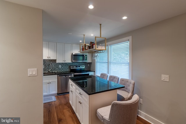 12306 Quail Woods Dr, Germantown, MD 20874 - kitchen featuring stainless steel appliances, dark wood-style flooring, white cabinetry, backsplash, and recessed lighting
