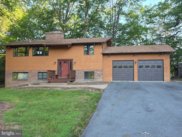 1780 Twirly Ct, Prince Frederick, MD 20678 - raised ranch featuring a chimney, driveway, an attached garage, and brick siding