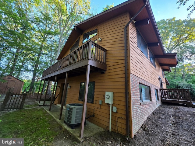 1780 Twirly Ct, Prince Frederick, MD 20678 - back of property featuring cooling unit, brick siding, and a deck