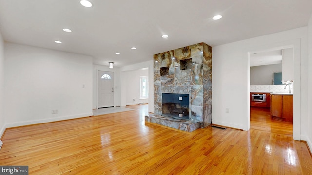 225 Dupont Cir, Wilmington, DE 19809 - unfurnished living room with light wood-type flooring, recessed lighting, and a large fireplace