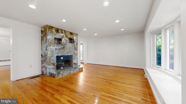 225 Dupont Cir, Wilmington, DE 19809 - unfurnished living room featuring healthy amount of natural light, a large fireplace, recessed lighting, and wood finished floors
