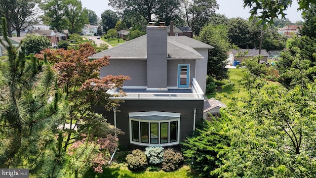 225 Dupont Cir, Wilmington, DE 19809 - rear view of property with a shingled roof and a chimney