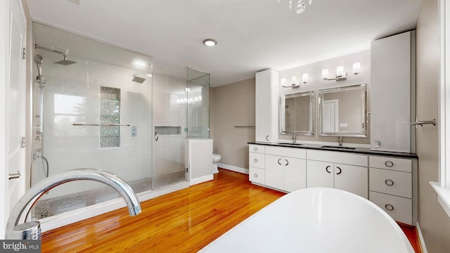 225 Dupont Cir, Wilmington, DE 19809 - bathroom with a shower stall, vanity, a freestanding bath, and wood finished floors
