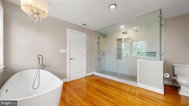 225 Dupont Cir, Wilmington, DE 19809 - full bathroom with a soaking tub, wood finished floors, a shower stall, and a chandelier