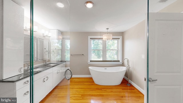 225 Dupont Cir, Wilmington, DE 19809 - full bath with double vanity, wood finished floors, a freestanding bath, and recessed lighting