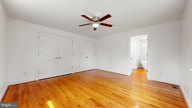 225 Dupont Cir, Wilmington, DE 19809 - unfurnished bedroom with light wood-style flooring, connected bathroom, and a ceiling fan