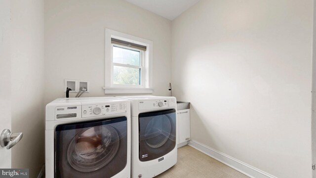 225 Dupont Cir, Wilmington, DE 19809 - laundry area featuring washing machine and clothes dryer and cabinet space