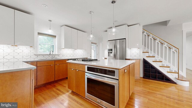 225 Dupont Cir, Wilmington, DE 19809 - kitchen with stainless steel appliances, light wood-style flooring, tasteful backsplash, modern cabinets, and recessed lighting