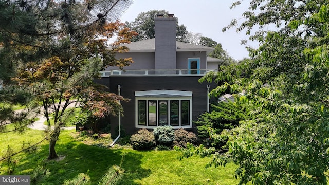 225 Dupont Cir, Wilmington, DE 19809 - rear view of property with a yard and a chimney
