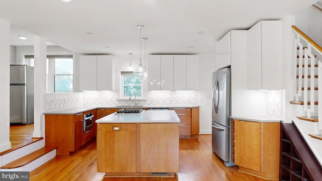 225 Dupont Cir, Wilmington, DE 19809 - kitchen with appliances with stainless steel finishes, a center island, modern cabinets, light wood-style floors, and recessed lighting