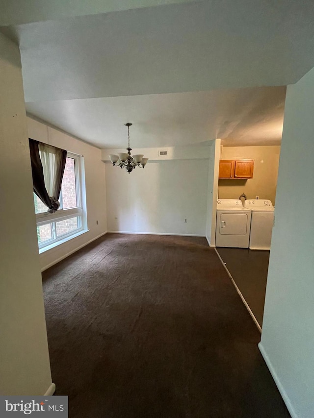 8477 Greenbelt Rd Unit 202, Greenbelt, MD 20770 - unfurnished dining area featuring washer and clothes dryer, a chandelier, dark carpet, and baseboards