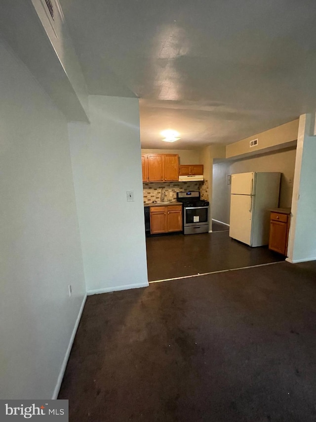 8477 Greenbelt Rd Unit 202, Greenbelt, MD 20770 - kitchen featuring stainless steel gas range oven, freestanding refrigerator, a sink, backsplash, and baseboards