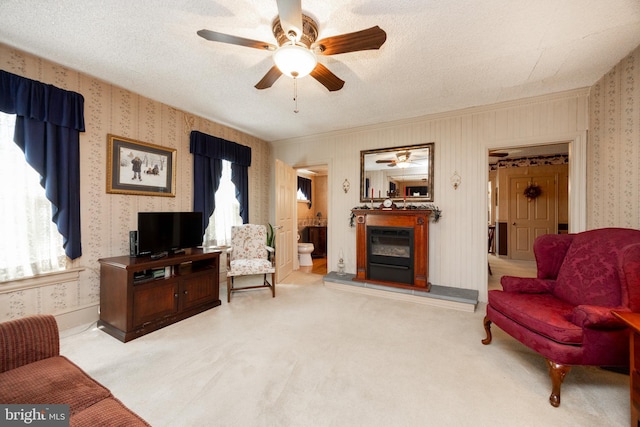 134 S 5th Ave, Royersford, PA 19468 - carpeted living area with ceiling fan, wallpapered walls, a glass covered fireplace, and ornamental molding