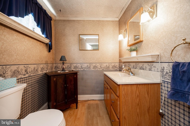 134 S 5th Ave, Royersford, PA 19468 - bathroom with toilet, wood finished floors, vanity, a textured ceiling, and crown molding