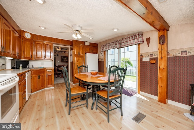 134 S 5th Ave, Royersford, PA 19468 - dining area featuring a textured ceiling, light wood finished floors, wallpapered walls, a ceiling fan, and baseboards
