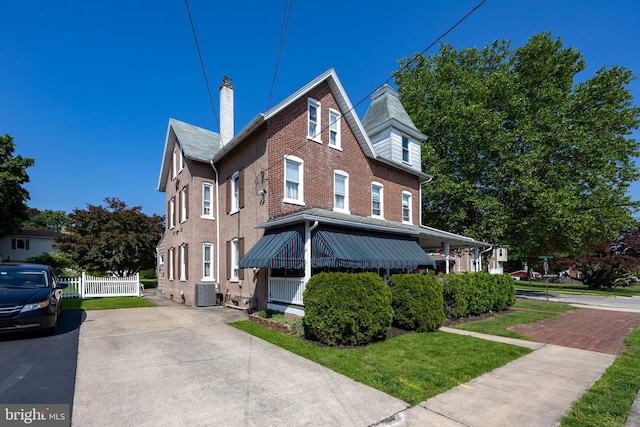 134 S 5th Ave, Royersford, PA 19468 - view of side of home featuring central air condition unit, a chimney, and brick siding