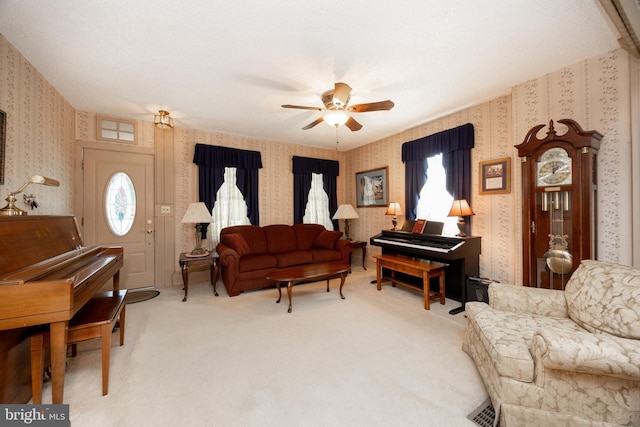134 S 5th Ave, Royersford, PA 19468 - living room featuring wallpapered walls, light colored carpet, ceiling fan, and healthy amount of natural light