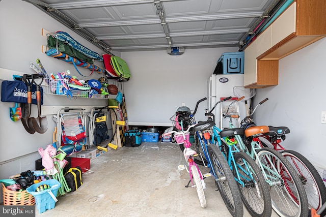 104 120th St Unit D82, Ocean City, MD 21842 - garage with a garage door opener and freestanding refrigerator