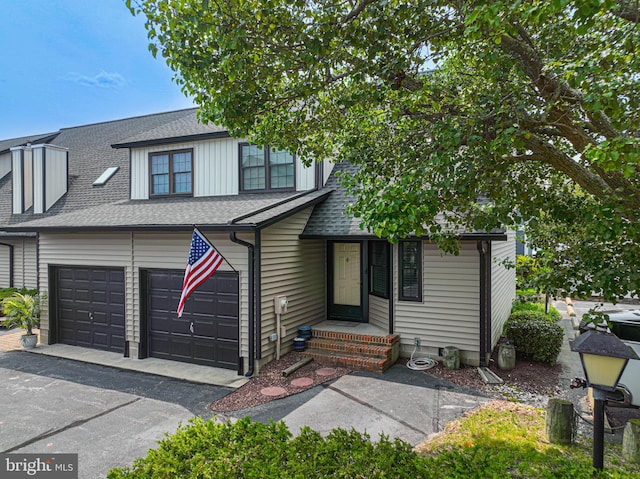 104 120th St Unit D82, Ocean City, MD 21842 - view of front of house featuring driveway, roof with shingles, and a garage