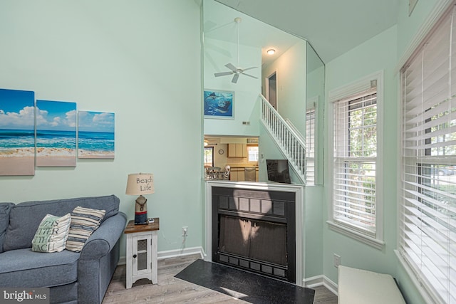 104 120th St Unit D82, Ocean City, MD 21842 - living area with wood finished floors, ceiling fan, a water view, baseboards, and a towering ceiling