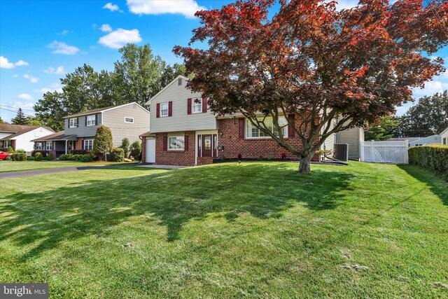 869 Primrose Dr, Warminster, PA 18974 - view of front of house with brick siding, cooling unit, and a garage