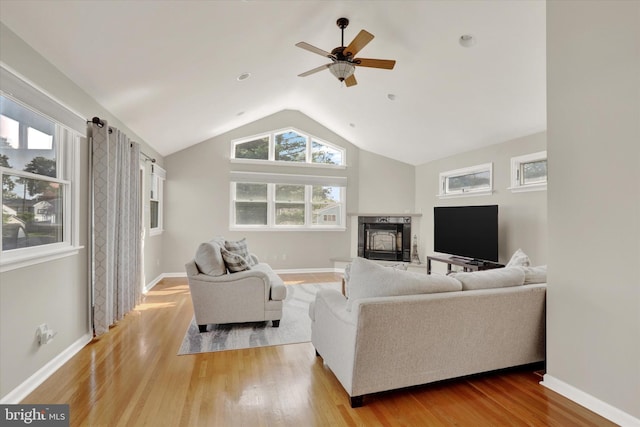 869 Primrose Dr, Warminster, PA 18974 - living area featuring lofted ceiling, a fireplace with raised hearth, wood finished floors, ceiling fan, and baseboards