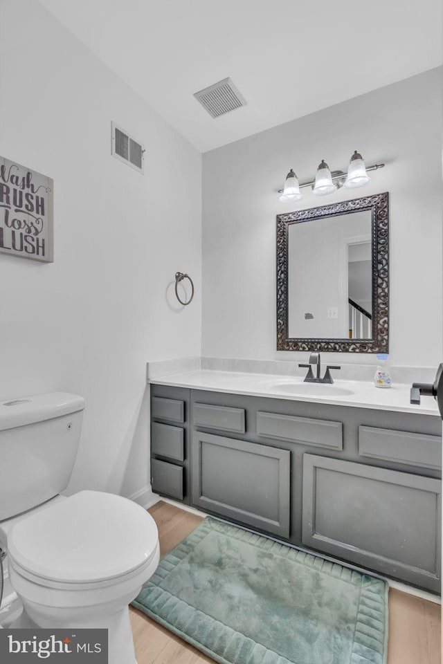 1606 Montmorency Dr, Vienna, VA 22182 - bathroom with wood finished floors, vanity, and toilet